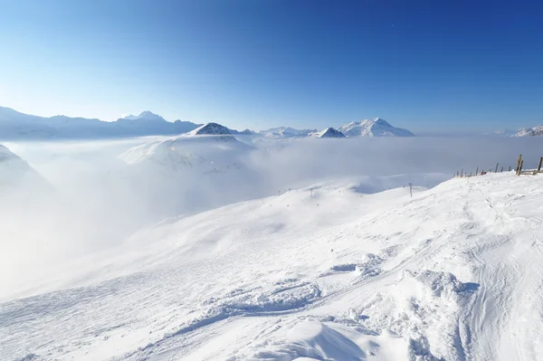 Montanhas em nuvens com neve no inverno — Fotografia de Stock