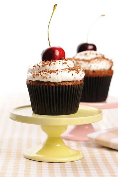 Cupcakes with whipped cream and cherry Stock Picture