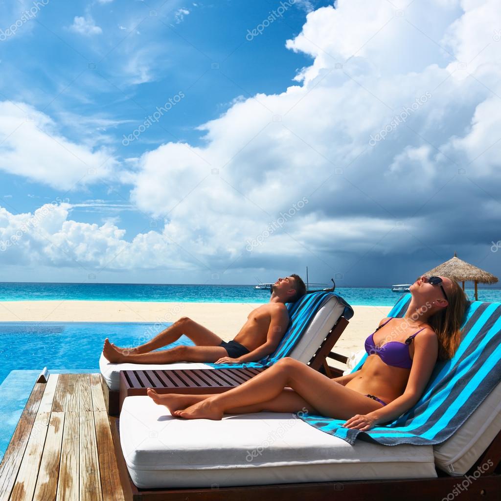 Couple relaxing at the poolside