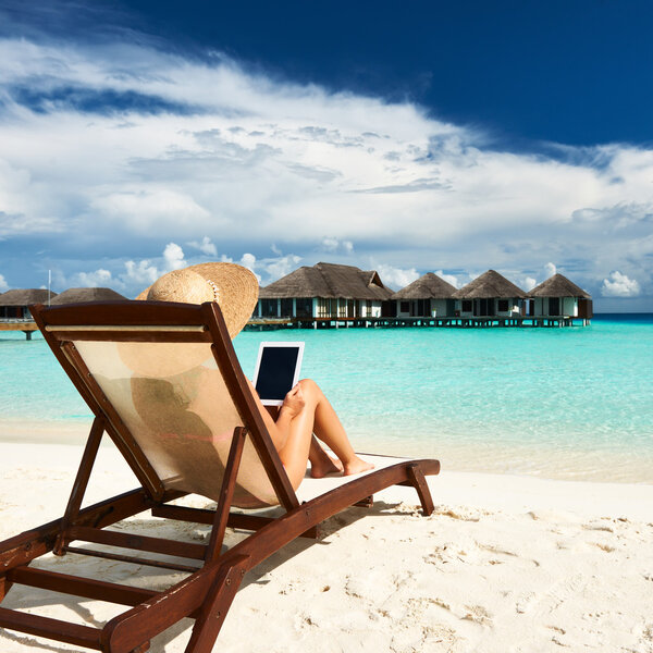 Young woman with tablet pc at the beach