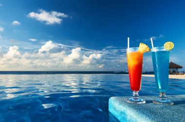 Cocktails near swimming pool clipart