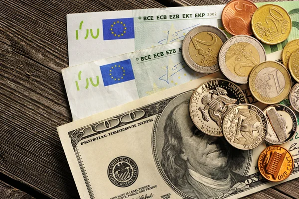 US and euro money over wooden background — Stock Photo, Image