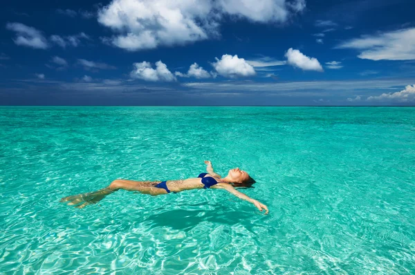 Woman in bikini lying on water Stock Image
