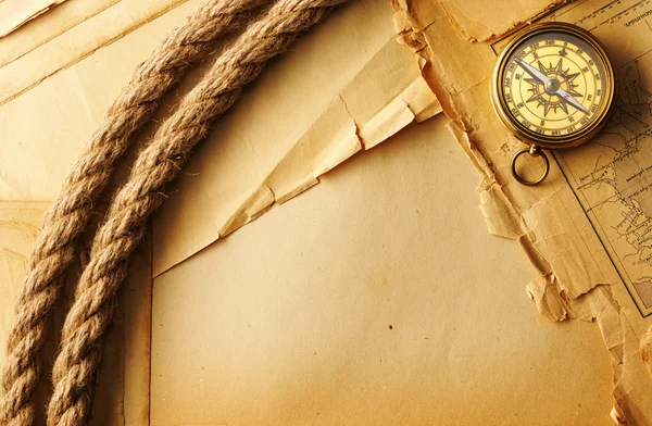 Antique compass and rope over old map — Stock Photo, Image