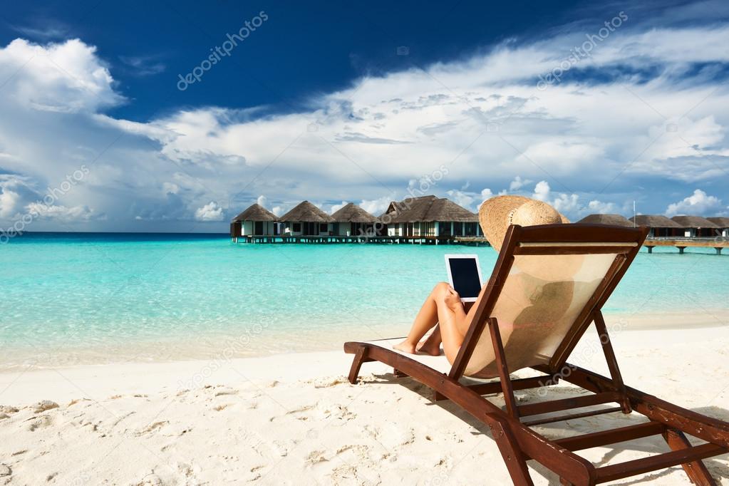 Young woman with tablet pc at the beach