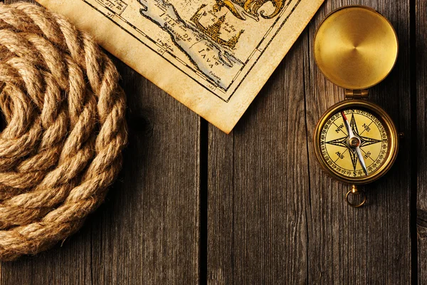 Antique compass and rope over old map — Stock Photo, Image