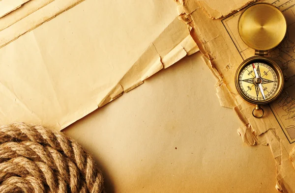 Antique compass and rope over old map — Stock Photo, Image