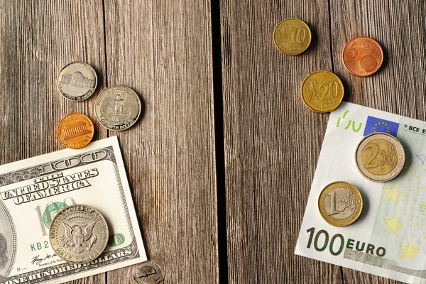 US and euro money over wooden background — Stock Photo, Image