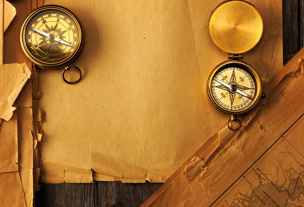 Antique compass over old map — Stock Photo, Image