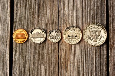 US cent coins over wooden background clipart