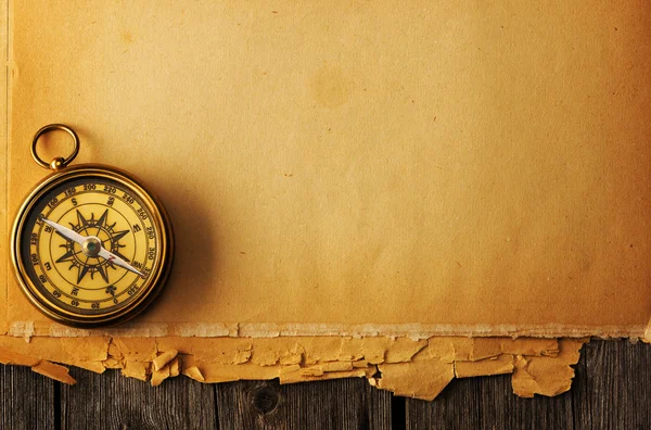 Antique brass compass over old background — Stock Photo, Image