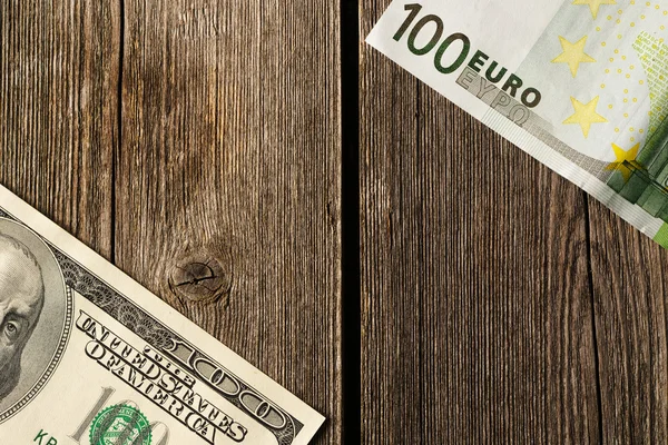 US and euro money over wooden background — Stock Photo, Image