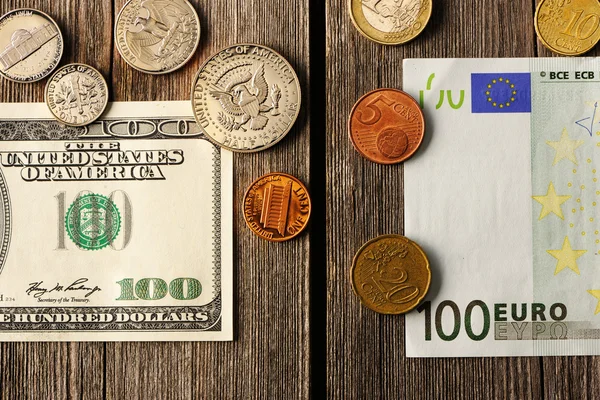 US and euro money over wooden background — Stock Photo, Image