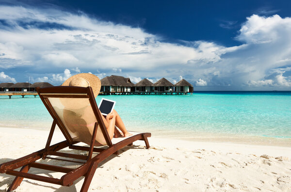 Young woman with tablet pc at the beach