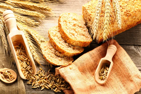 Roggen-Stacheln und Brot-Stillleben auf Holzgrund — Stockfoto