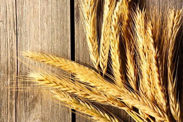 Rye spikelets over wooden background — Stock Photo, Image