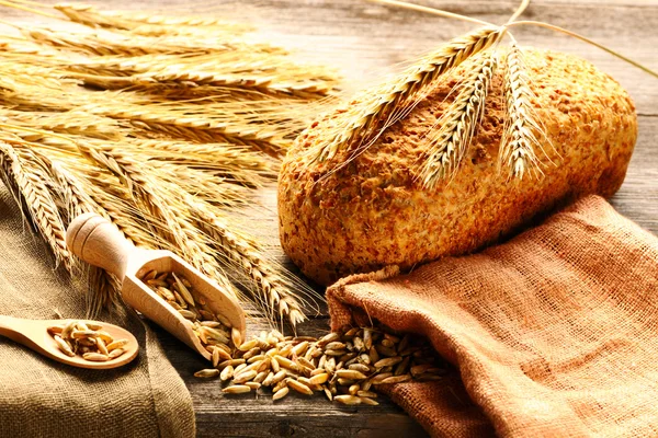 Ржаные шипы и хлеб натюрморт на деревянном фоне — стоковое фото