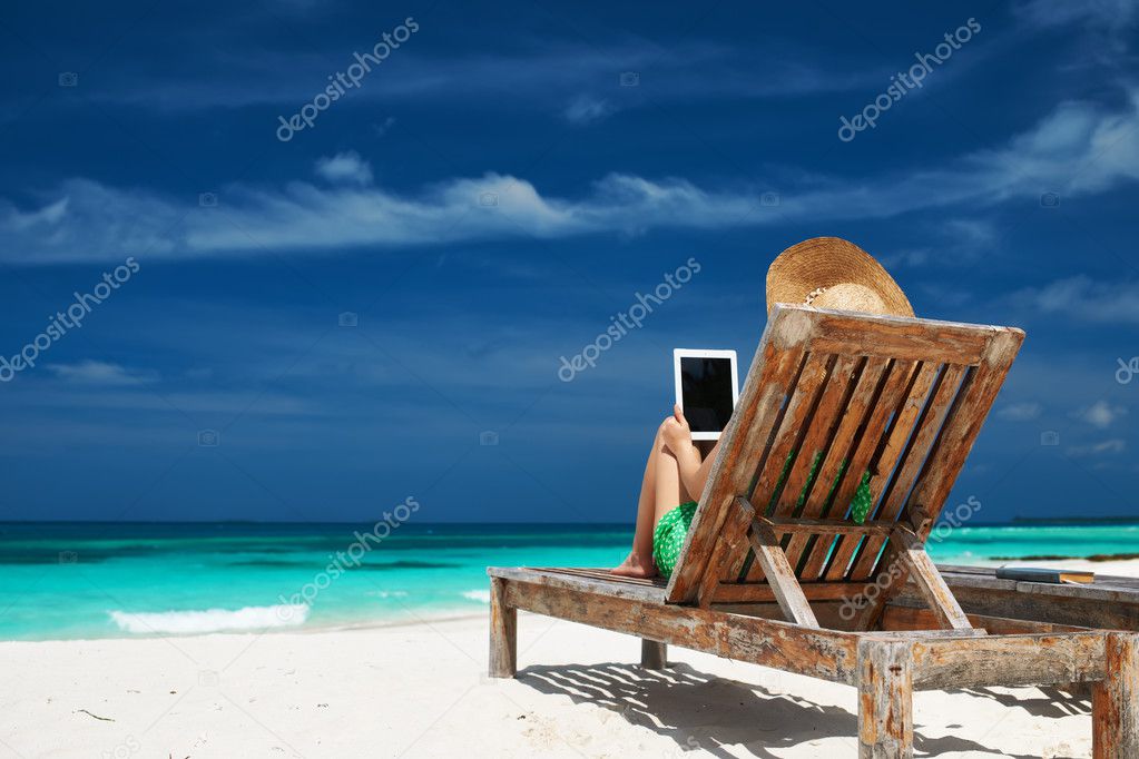 Young woman with tablet pc at the beach