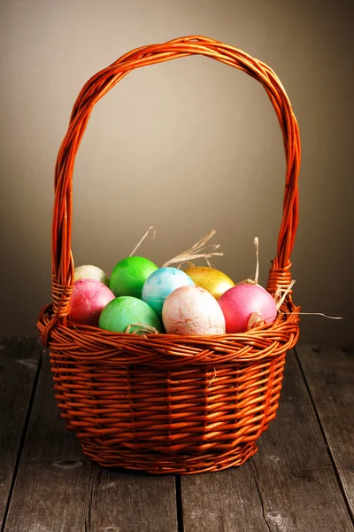 Colored easter eggs in basket — Stock Photo, Image