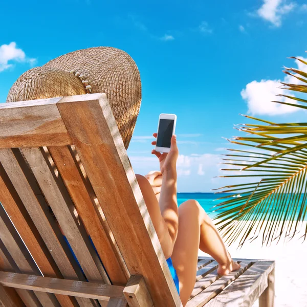 Ung kvinna med TabletPC på stranden — Stockfoto