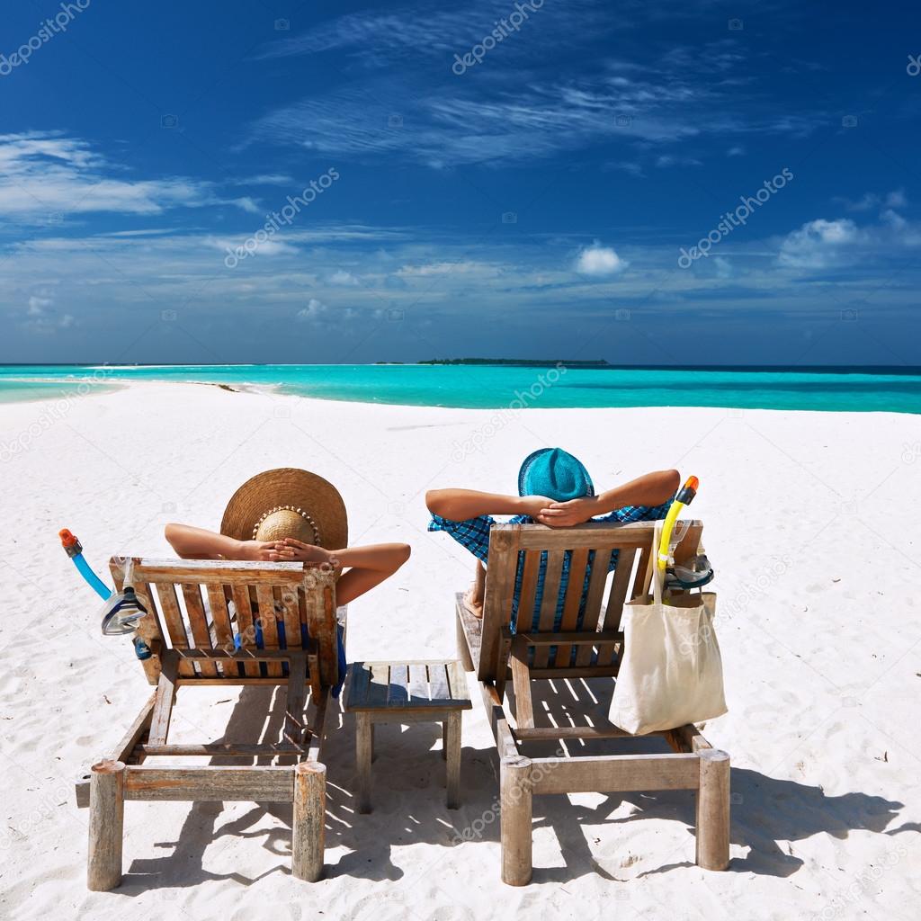 Couple relax on a beach at Maldives