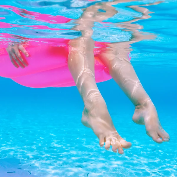 Woman relaxing on inflatable mattress, view from underwater — Stock Photo, Image