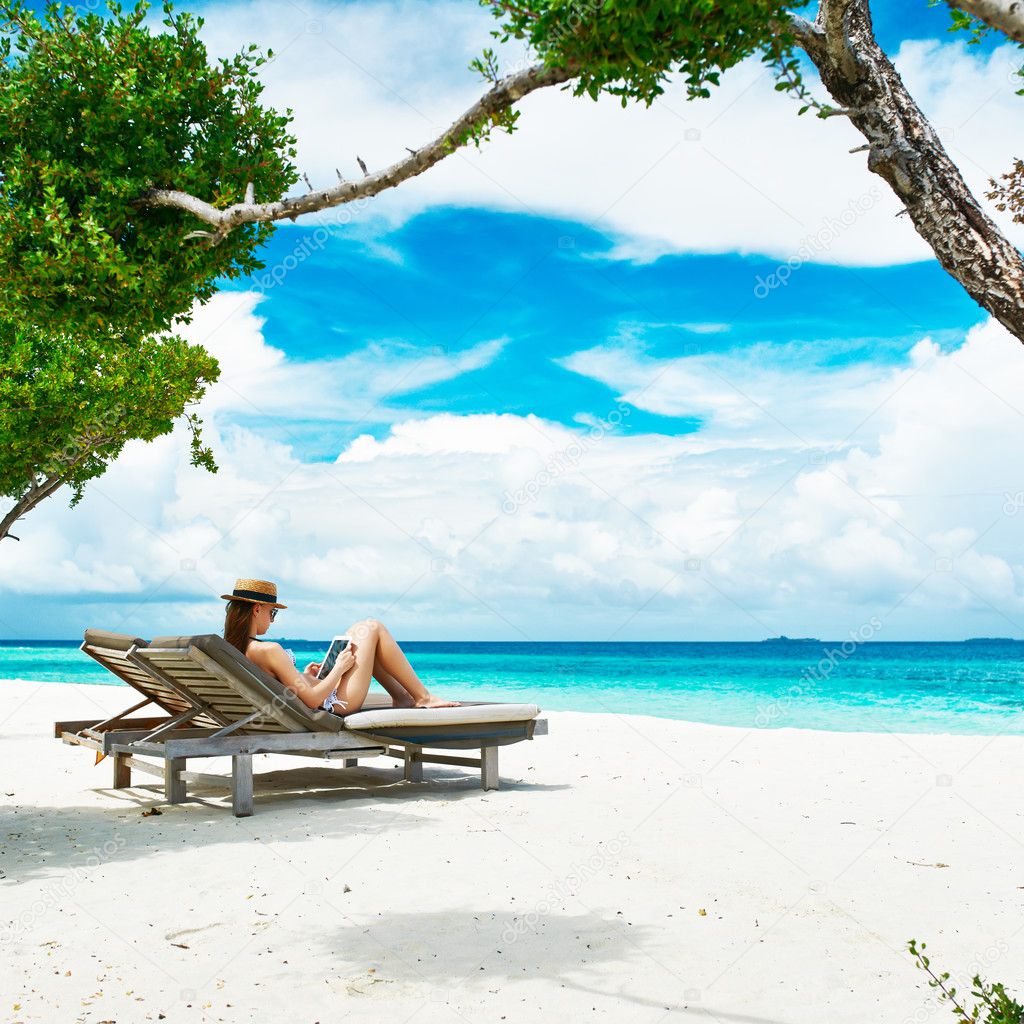 Young woman with tablet pc at the beach