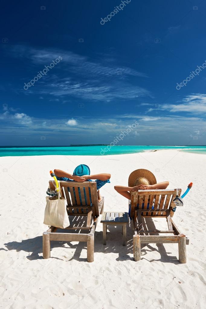 Couple relax on a beach at Maldives