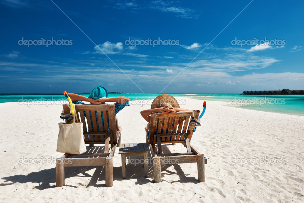 Couple relax on a beach at Maldives