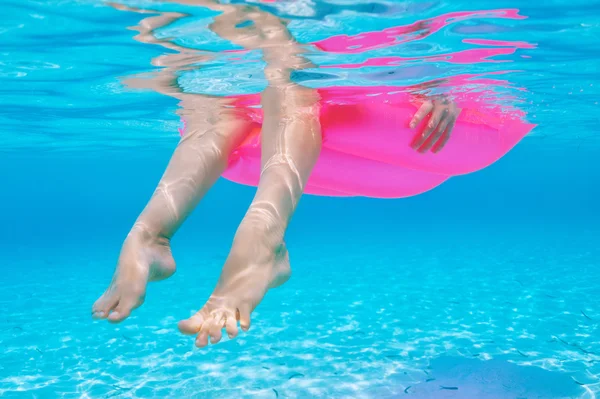 Woman relaxing on inflatable mattress, view from underwater — Stock Photo, Image