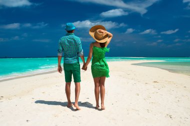 Couple on beach at Maldives clipart