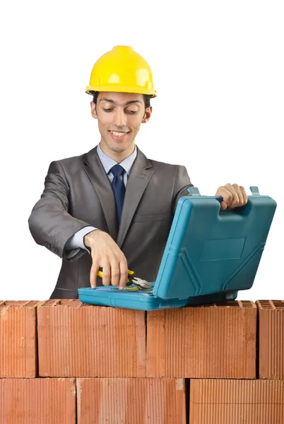 Businessman with bricks on white — Stok fotoğraf