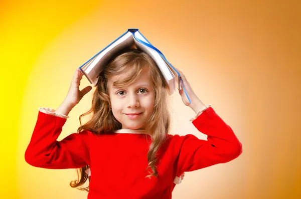 Kleines Mädchen mit Büchern auf weiß — Stockfoto