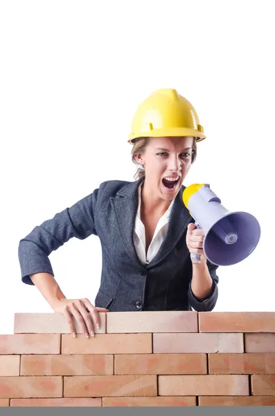 Woman builder with loudspeaker on white — Stock Photo, Image