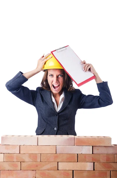 Woman builder and brick wall — Stock Photo, Image
