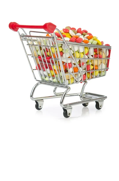 Carrito de compras con muchas píldoras de colores —  Fotos de Stock