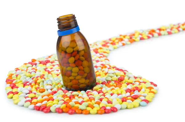 Butelka z wielu kolorowych tabletek — Zdjęcie stockowe