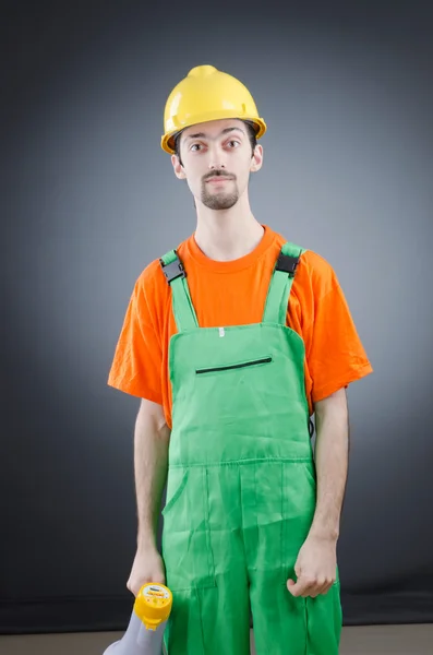 Construction worker with loudspeaker in studio — Stock Photo, Image