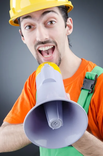 Construction worker with loudspeaker in studio — Stock Photo, Image