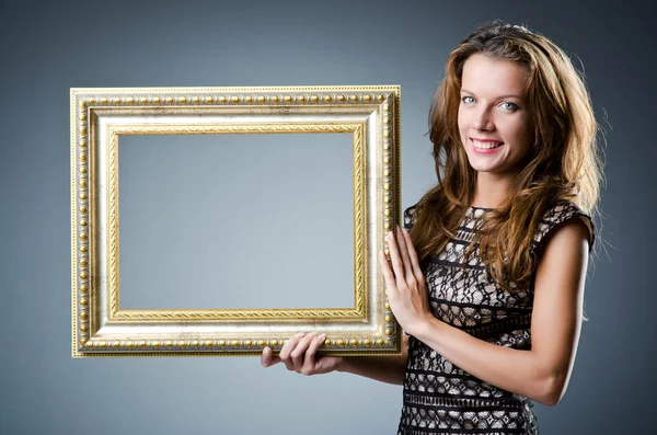 Young woman with picture frame on white — Stock Photo, Image