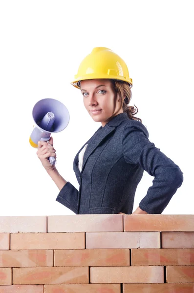 Woman builder with loudspeaker on white — Stock Photo, Image