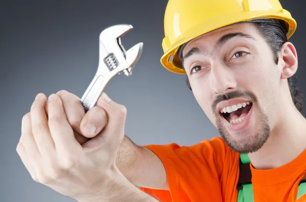 Man with a wrench in a studio — Stock Photo, Image