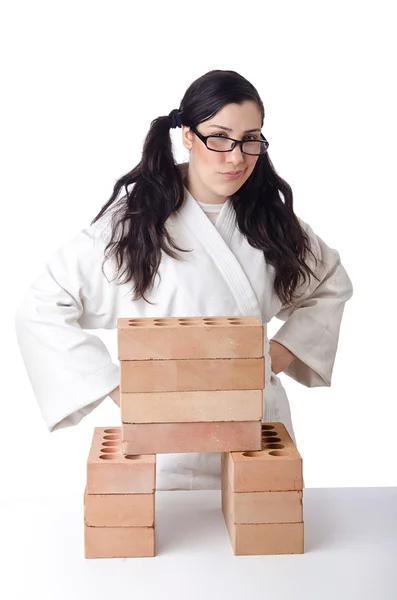 Woman karate breaking bricks on white — Stock Photo, Image