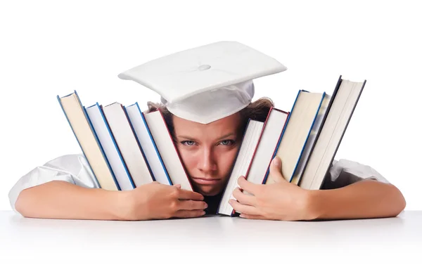 Happy graduate with lots of books on white — Stock Photo, Image