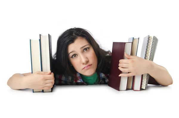 Estudante cansado com livros didáticos sobre branco — Fotografia de Stock