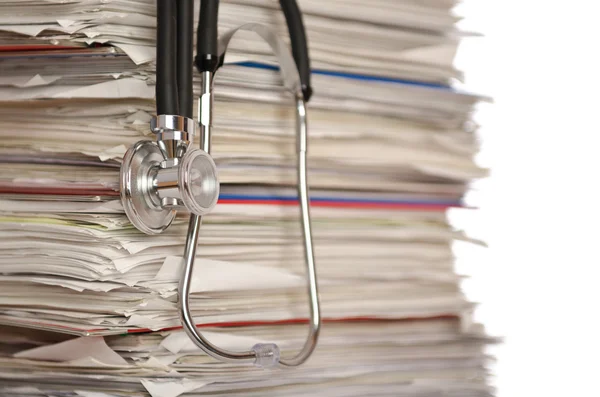Stack of papers with stethoscope — Stock Photo, Image