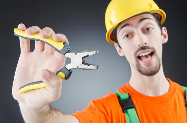 Man with tongs in studio — Stock Photo, Image