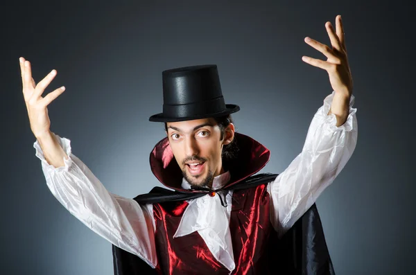 Magician doing tricks in dark room — Stock Photo, Image