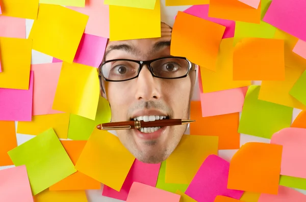 Man's face through paper and reminders — Stock Photo, Image