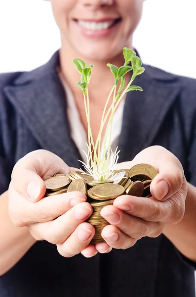 Empresaria con plántulas y monedas —  Fotos de Stock